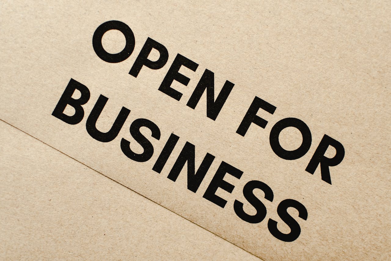 services-03 Close-up of an 'Open for Business' sign on a textured brown paper background.